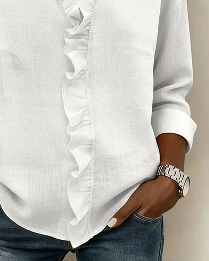 Women's white V-neck ruffle blouse with long sleeves, made from a lightweight fabric.