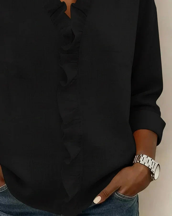 White women's V-neck ruffle blouse with long sleeves, featuring a relaxed fit.
