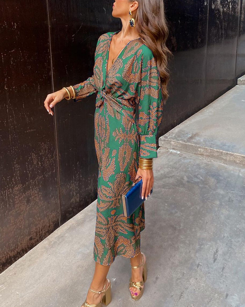 Green and gold printed Josephine A-line maxi dress with a V-neckline and front knot detail.