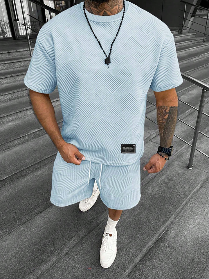 Men's light blue textured t-shirt and drawstring shorts set with a tonal geometric pattern.