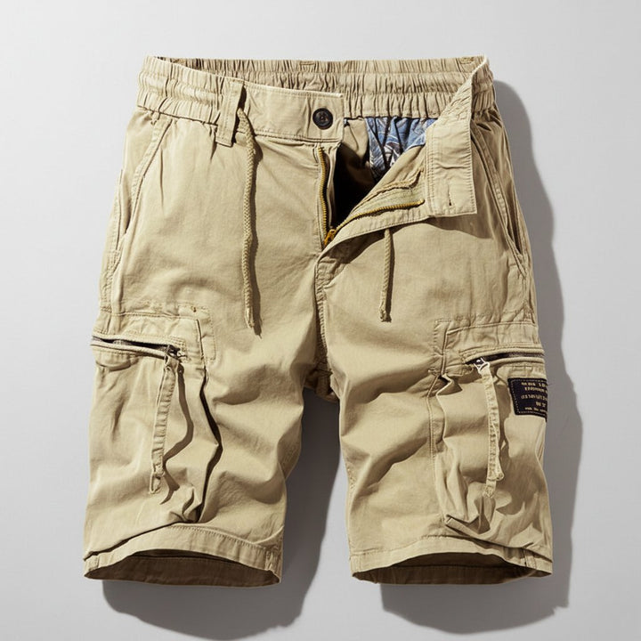 Leo men's tan elastic waist cargo shorts with drawstring, zip fly, and practical side pockets.