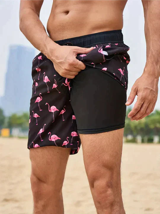 Men's Liam black swim shorts with pink flamingo pattern, drawstring waist, and built-in inner lining.