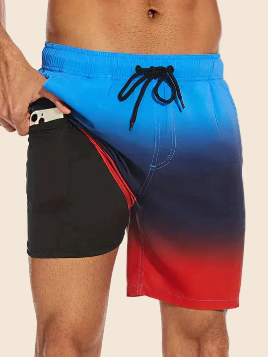 Men's Liam drawstring swim shorts with blue to red ombre pattern, black lining, and inner phone pocket.