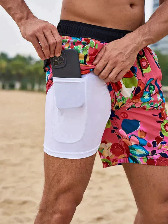 Men's Liam drawstring swim shorts in a vibrant floral pattern, featuring a white inner lining with a phone pocket.