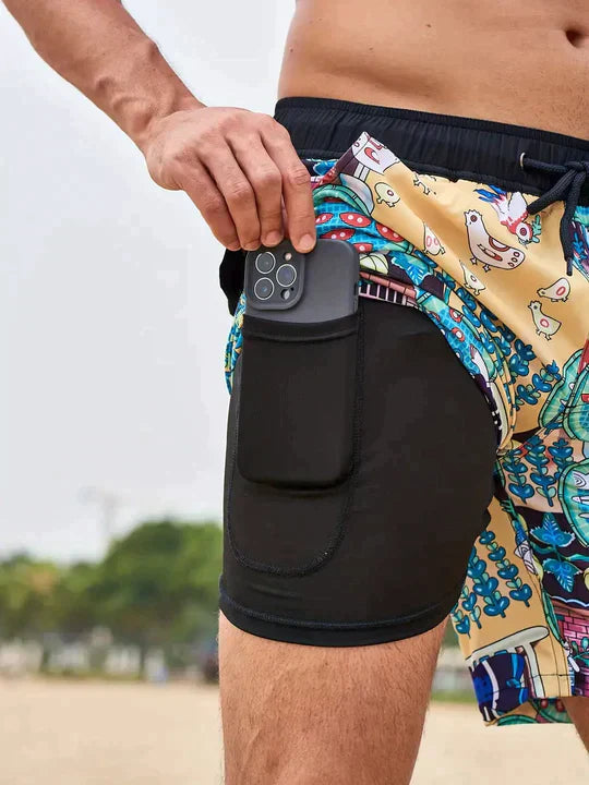 Men's Liam patterned swim shorts with black inner lining and a side pocket holding a phone.