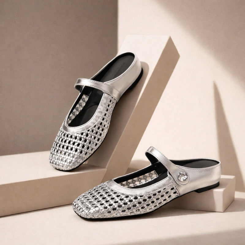 Silver woven metallic Mary Jane flat slip-on mules with a single strap and button detail.