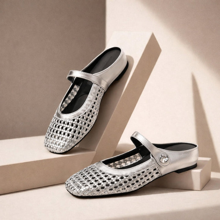 Silver woven metallic Mary Jane flat slip-on mules with a single strap and button detail.