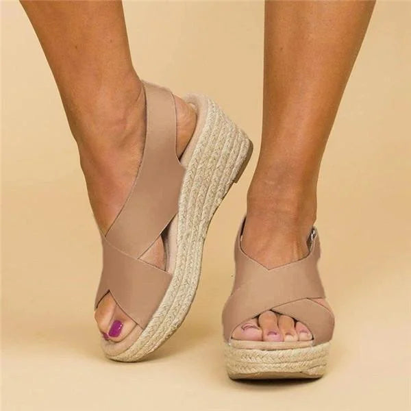 Beige women's orthopedic wedge sandals with a cushioned footbed and crisscross straps.