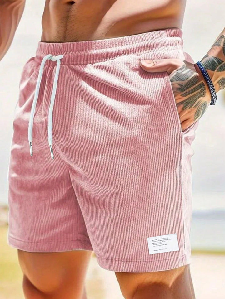 Men's Mason drawstring casual shorts in a relaxed fit, featuring soft pink corduroy, white drawstring, and side pockets.