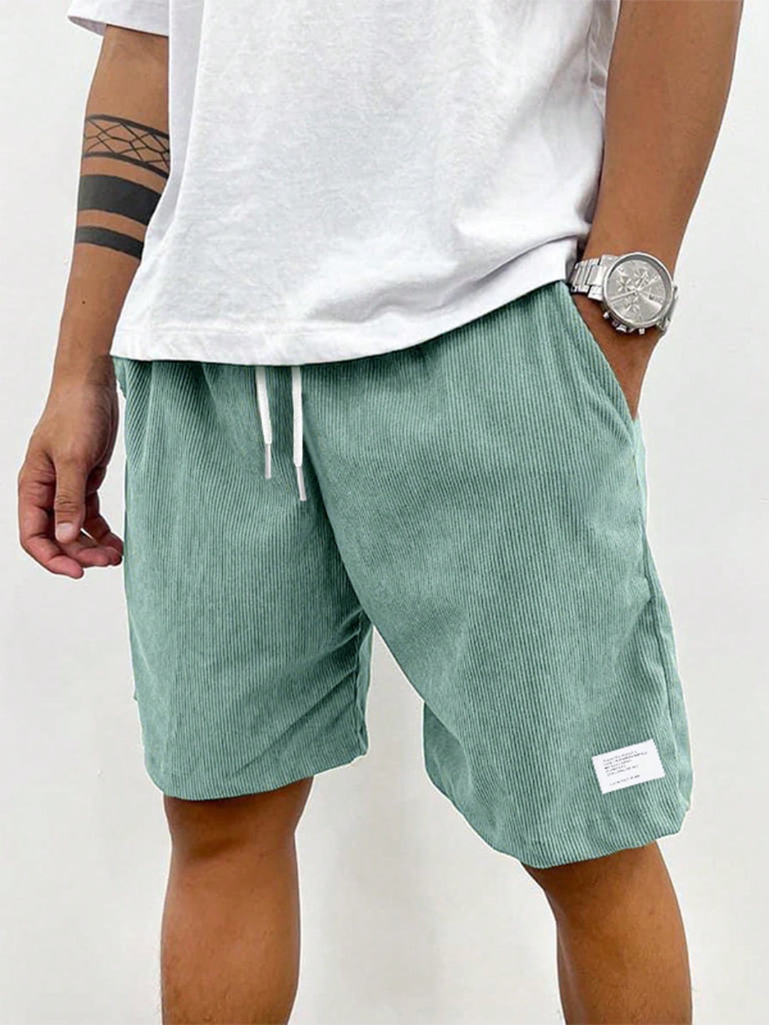 Men's Mason drawstring casual shorts in a relaxed fit, featuring a light green corduroy fabric and white drawstrings.