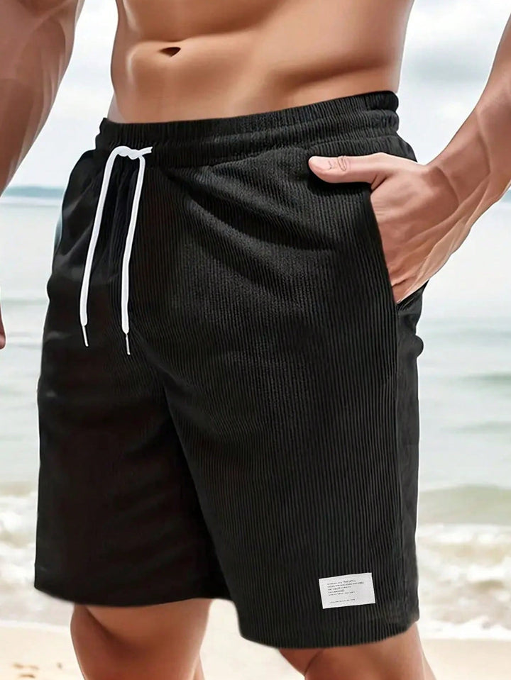 Men's Mason black ribbed drawstring casual shorts with white tie, perfect for easy summer style.