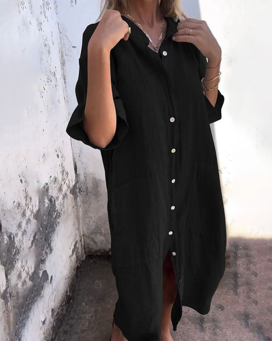 Mina black plus size shirt dress with white buttons, relaxed fit, and front pockets.