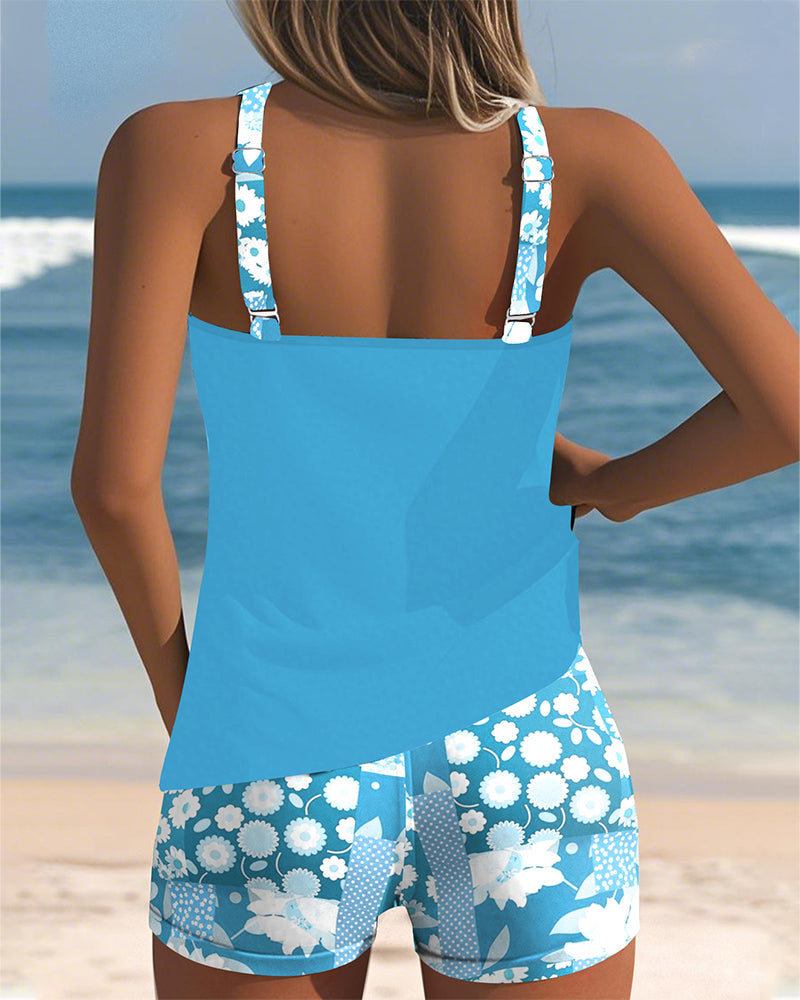 Women's Mirelle tankini with shorts, black top, and floral print bottoms.