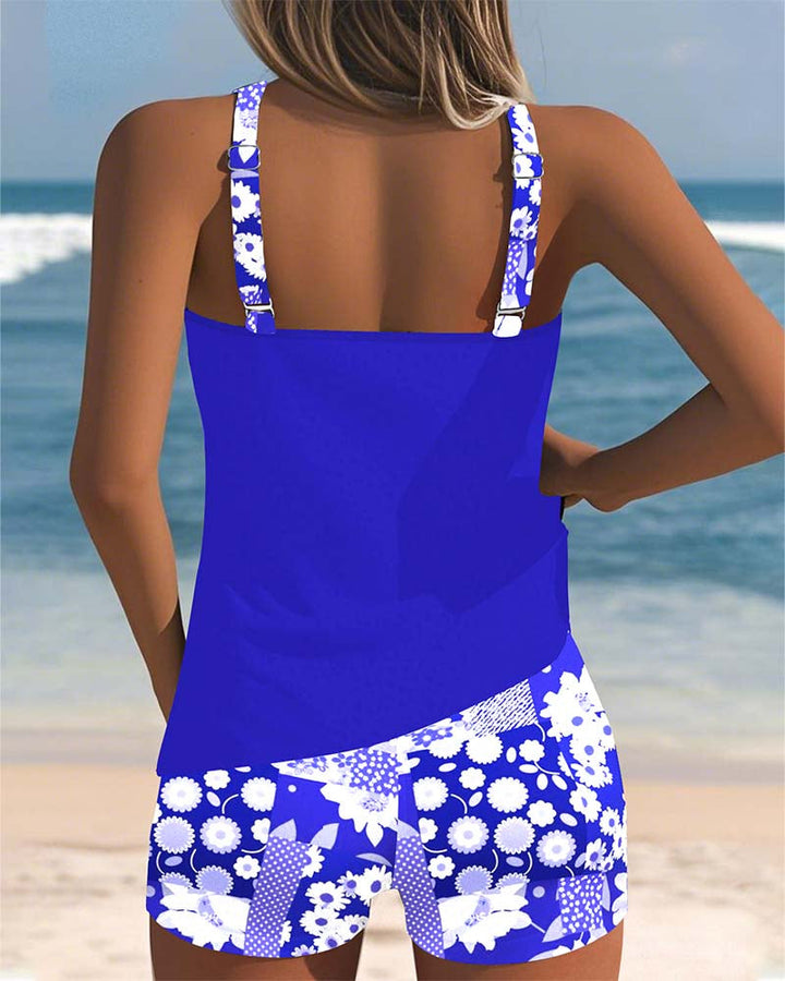 Women's Mirelle tankini with shorts, black top, and floral print bottoms.