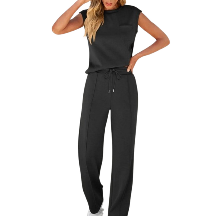 Woman wearing the black Noelle soft lounge co-ord set with sleeveless top and drawstring pants.