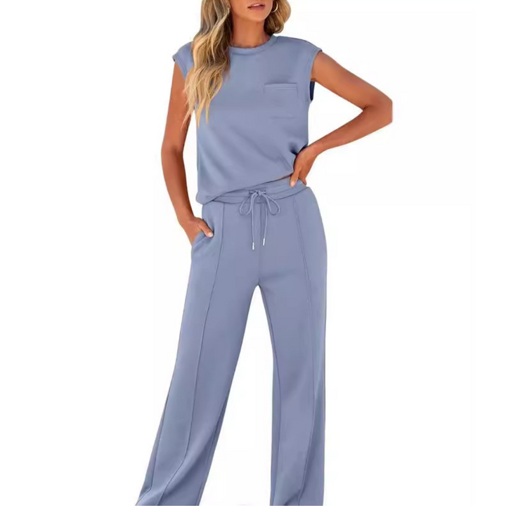 Woman wearing the Noelle blue soft lounge co-ord set with sleeveless top and drawstring pants.