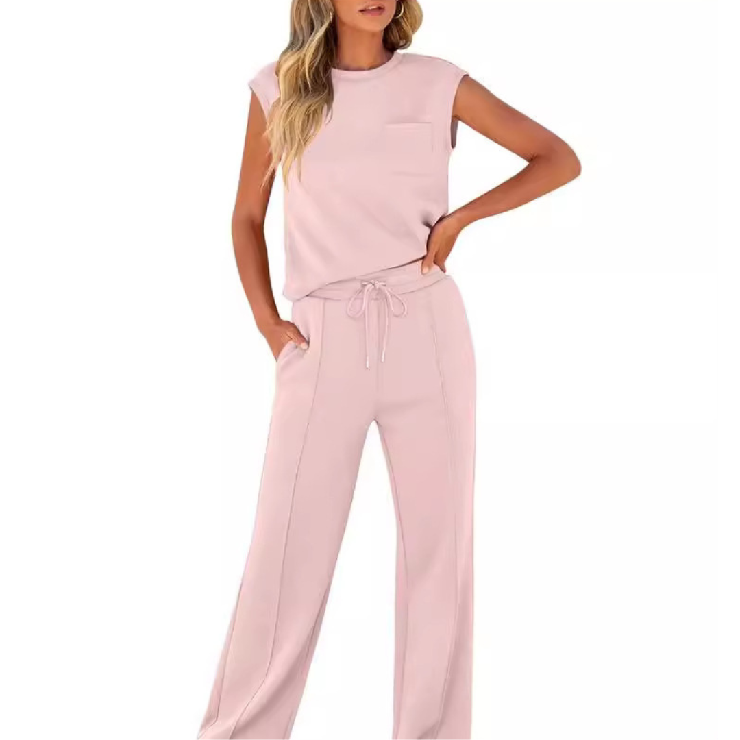 Woman wearing the Noelle light pink sleeveless top and drawstring wide-leg lounge pants set.