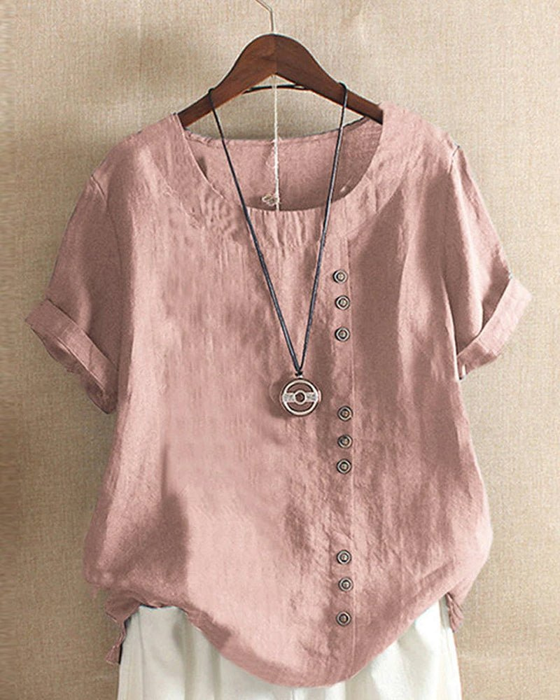 Dusty pink linen tunic top with a relaxed fit, short rolled sleeves, and an asymmetrical button-front detail.