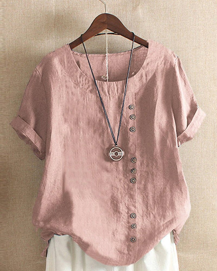 Dusty pink linen tunic top with a relaxed fit, short rolled sleeves, and an asymmetrical button-front detail.