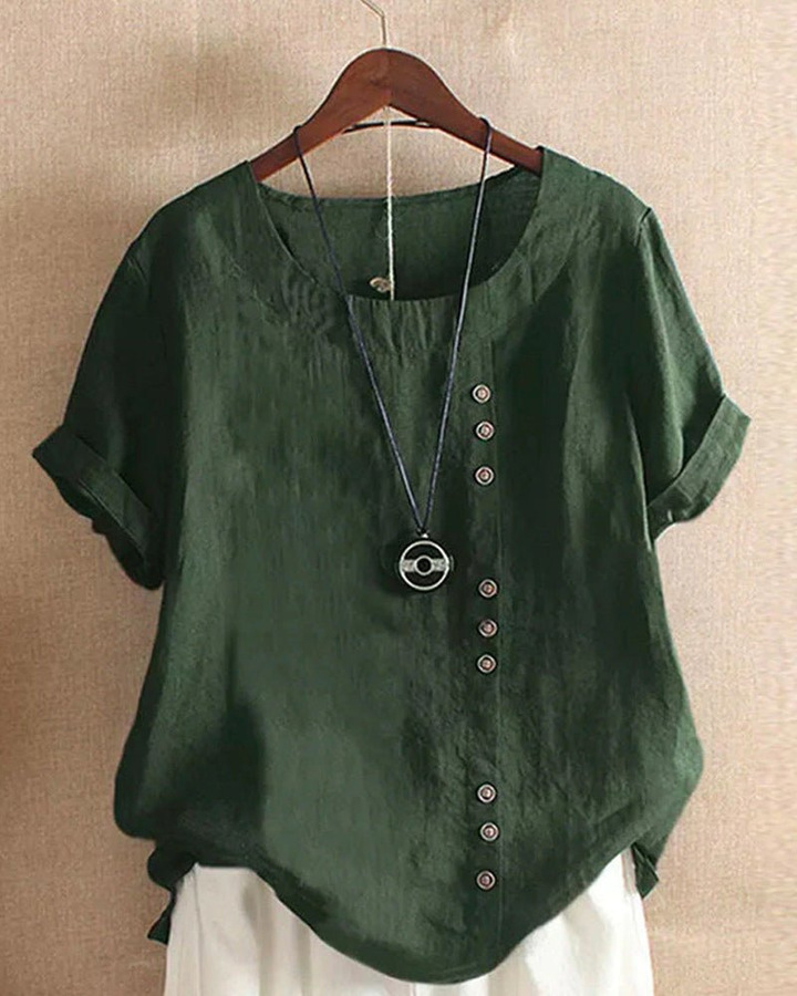 Dark green linen tunic top with a relaxed fit, side button-front detail, and rolled short sleeves on a hanger.