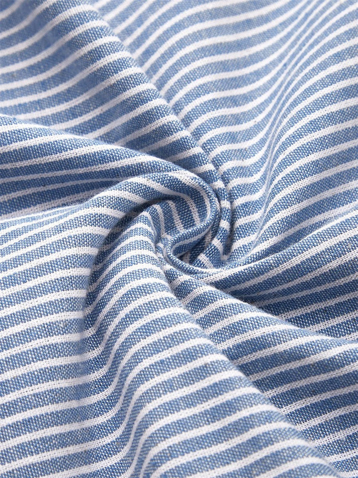 Close-up of the Nora dress fabric: classic blue and white striped, lightweight material.