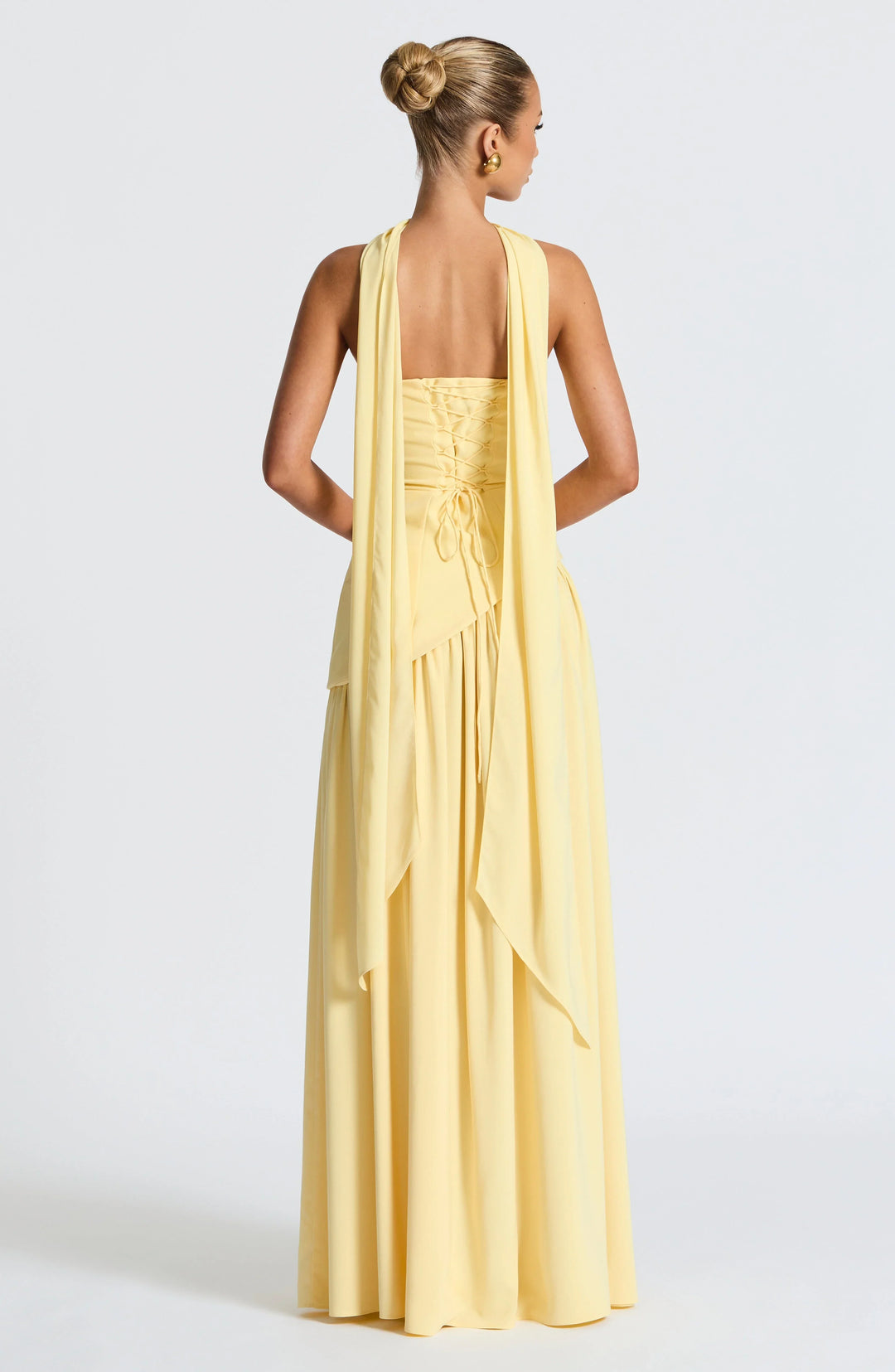 Black strapless corset maxi dress with a high slit, made from a sleek, form-fitting fabric.
