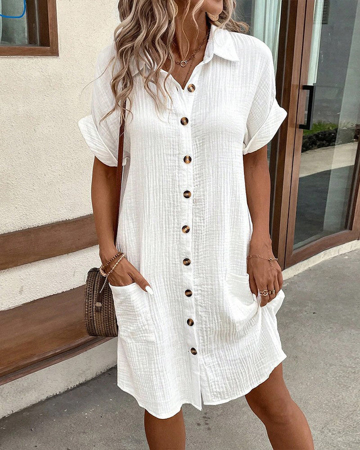White cotton button-up shirt dress with pockets and short sleeves