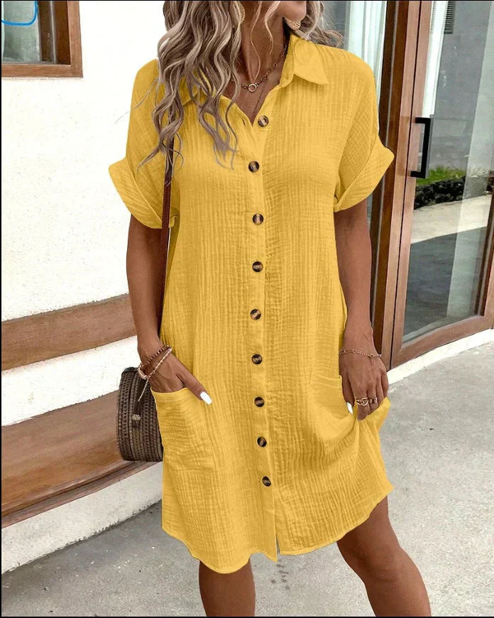 Yellow cotton button-up shirt dress with short sleeves and front pockets.