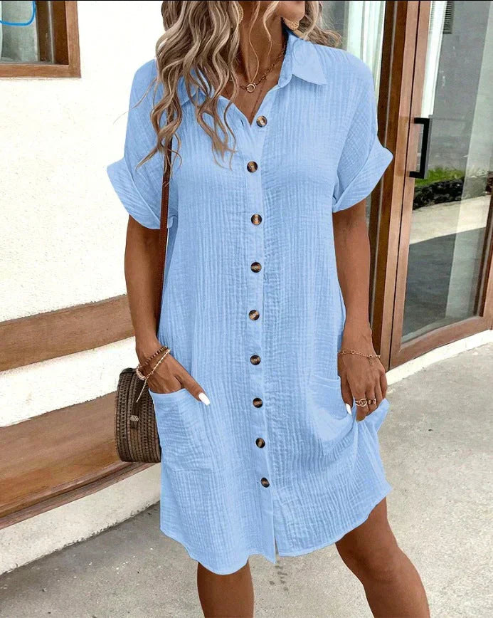 Light blue cotton button-up shirt dress with short sleeves and pockets