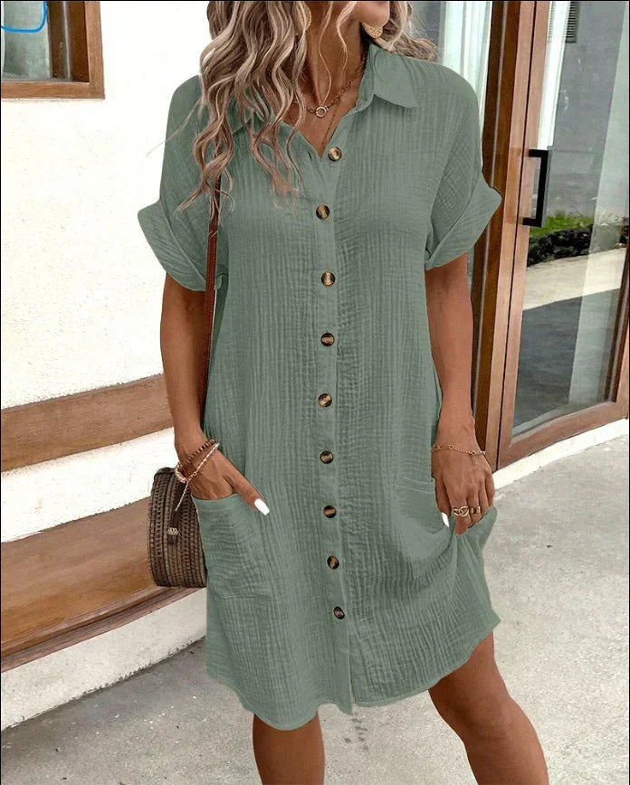 Sage green cotton button-up shirt dress with short cuffed sleeves and pockets.