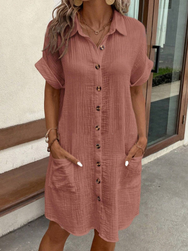 Woman wearing the Odette dusty rose cotton button-up shirt dress with pockets.