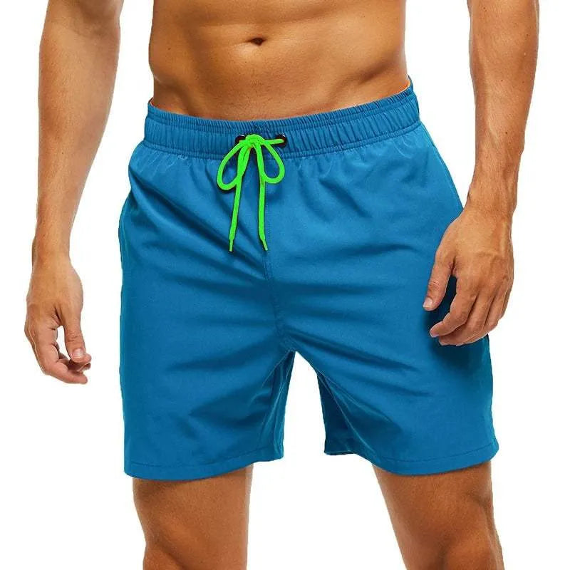 Men's blue quick-dry swim shorts with a bright green drawstring waistband.
