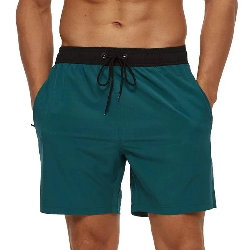 Men's teal quick-dry swim shorts with a black drawstring waistband.