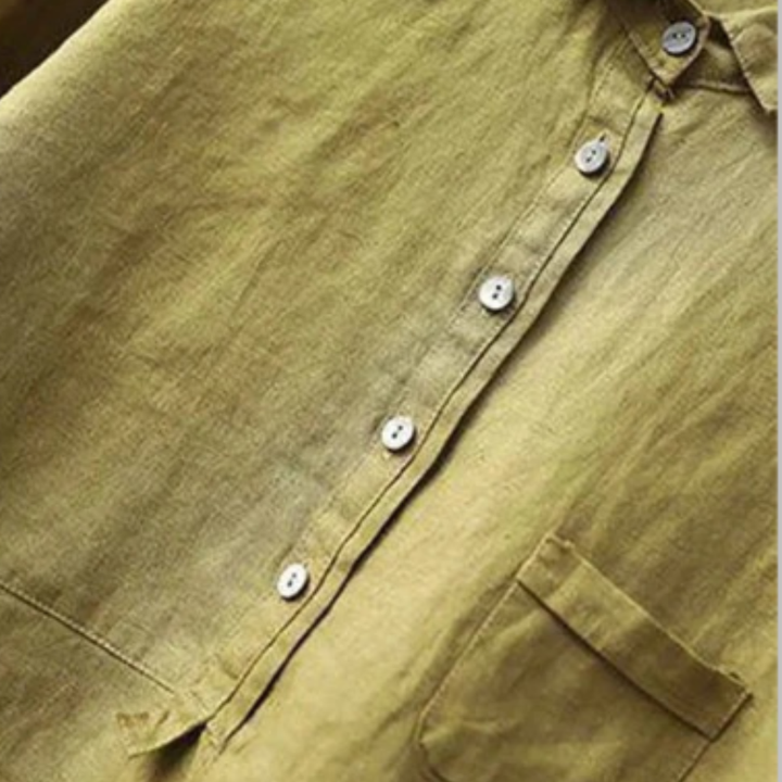 Close-up of the Rosalie olive green linen blouse featuring a half-placket button front and pocket.