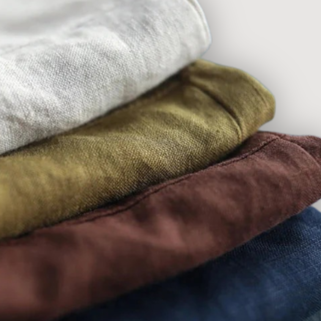 Folded Rosalie linen blouses in white, olive green, brown, and navy blue.