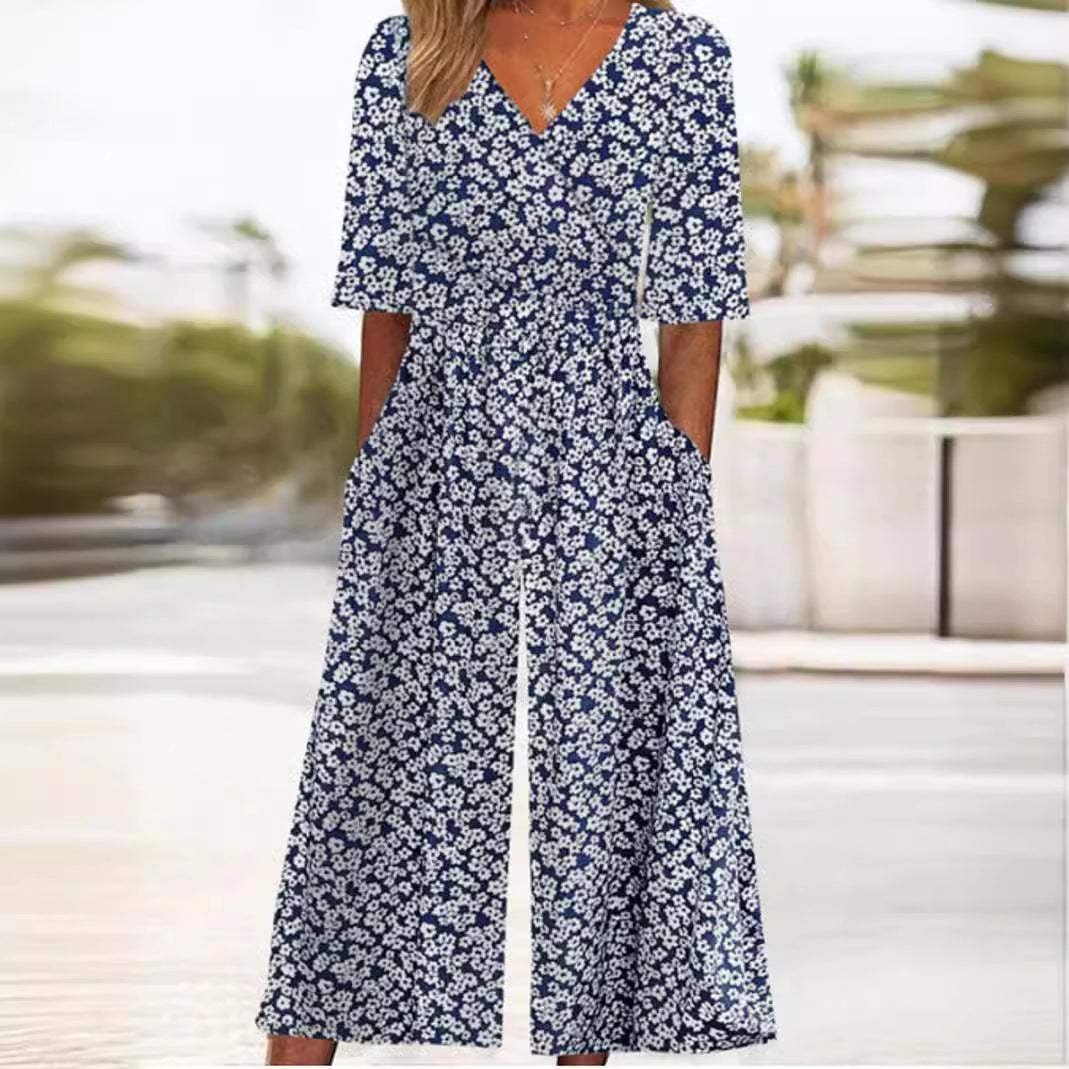Women's Scarlett navy blue floral V-neck wide-leg jumpsuit with half sleeves and pockets.