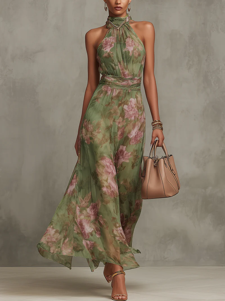 Sophia women's floral halter maxi dress in flowing green chiffon with pink flowers, defined waist, and gold accessories.