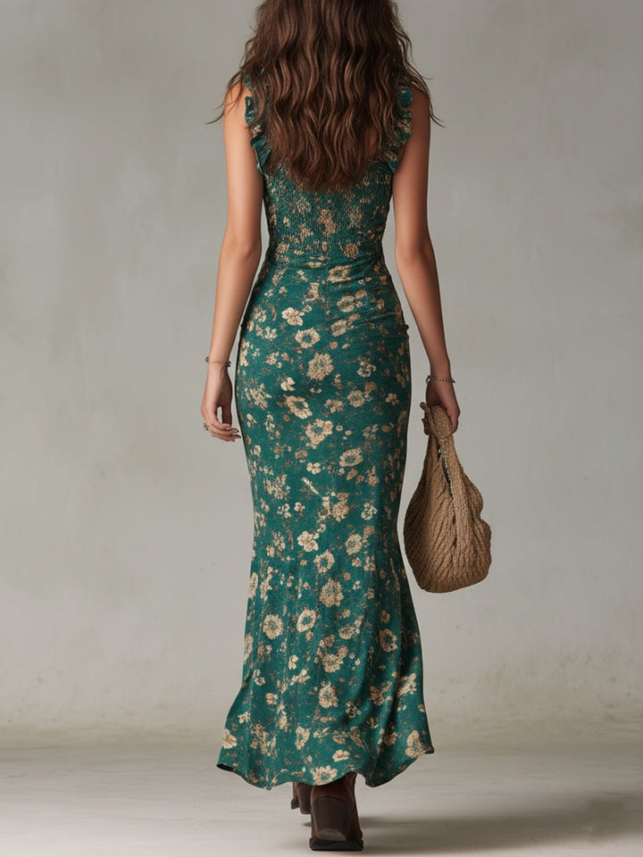 Woman from behind wearing a green floral smocked maxi dress with ruffle straps and holding a woven bag.