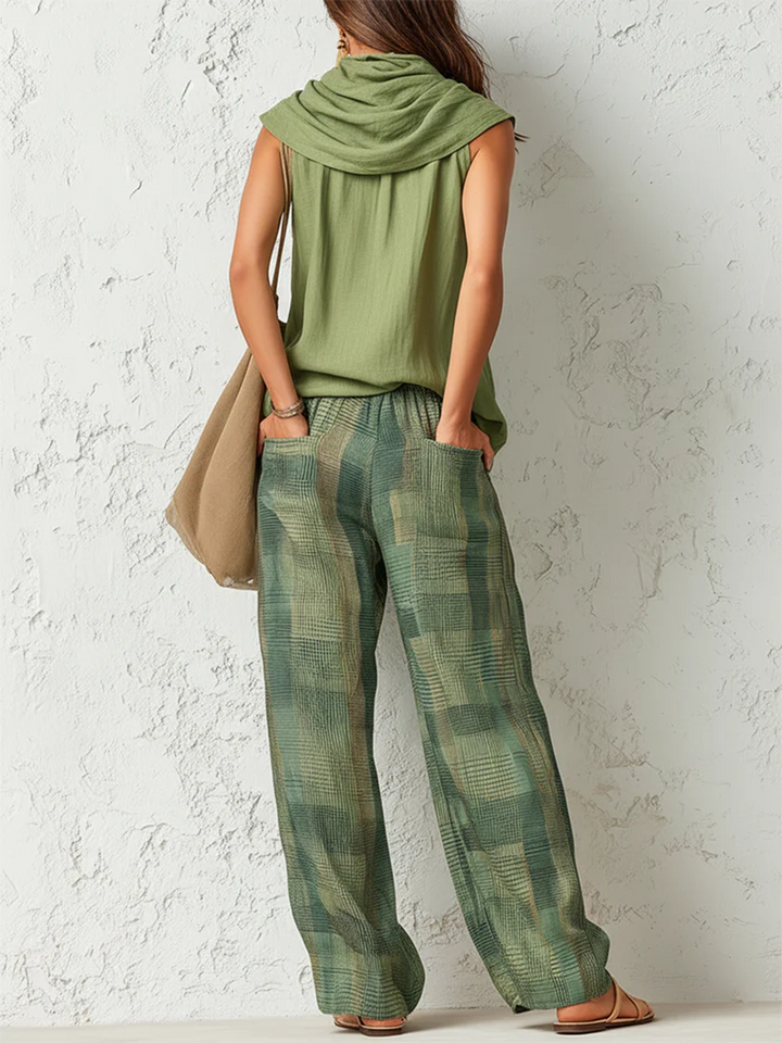 Woman from behind wearing the Stella green sleeveless blouse and patterned wide-leg pants set.