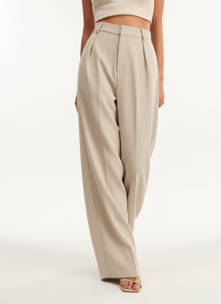 Stella women's high-waist wide-leg pants in a flowing beige fabric, showcasing refined tailoring.
