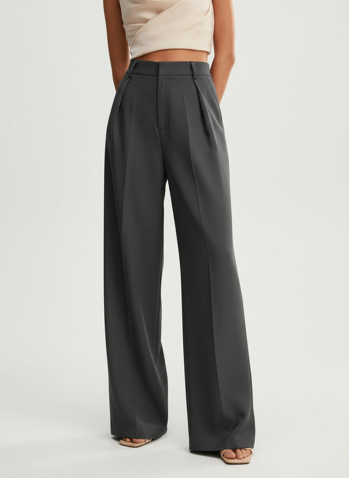 Stella women's high-waist, wide-leg charcoal gray tailored pants with elegant pleats and a flowing cut.