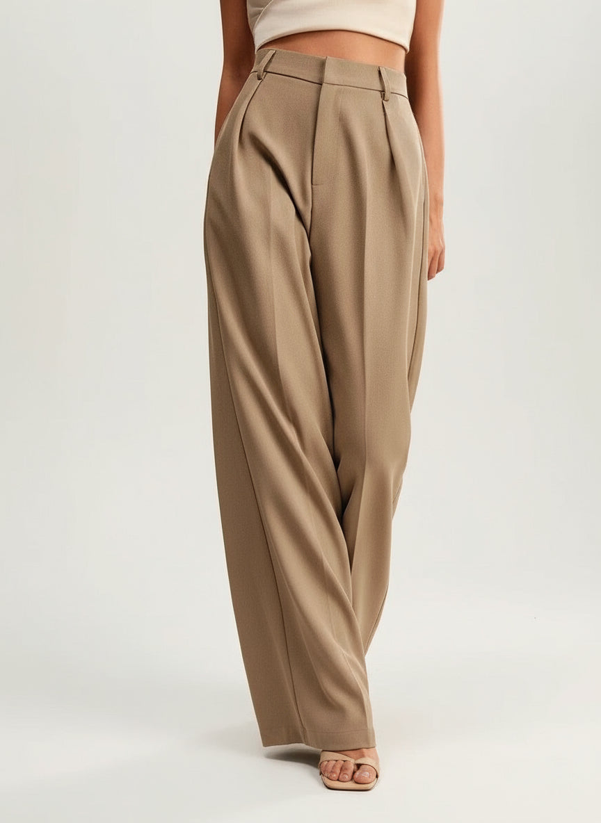 Stella women's high-waist wide-leg pants in a flowing tan fabric, featuring refined tailoring and a sleek design.