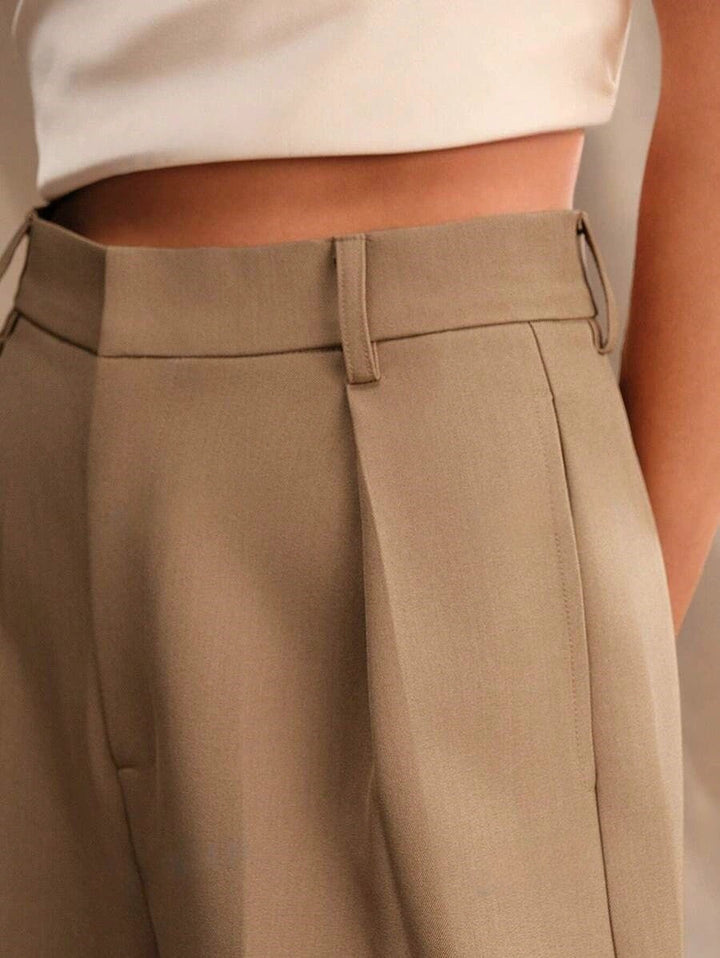 Stella women's high-waist wide-leg pants in a refined tan, showcasing tailored lines and a sleek, confident fit.