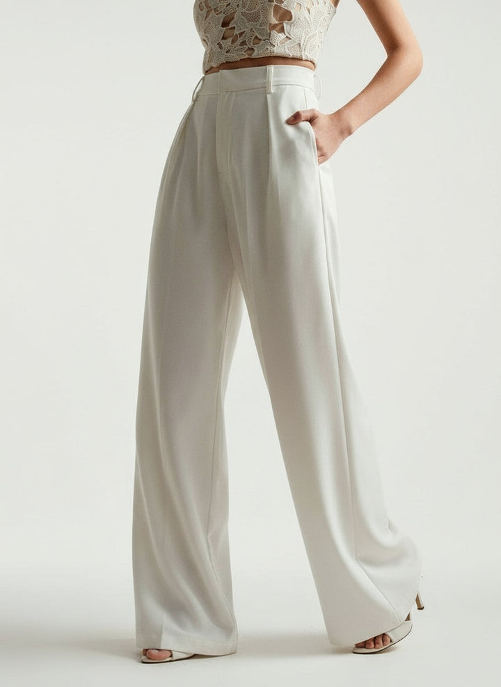 Stella women's high-waist wide-leg pants in crisp white, featuring tailored lines and a flowing silhouette.