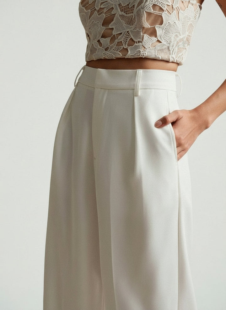 Stella women's high-waist wide-leg pants in a crisp off-white, featuring tailored lines and a flowing cut.