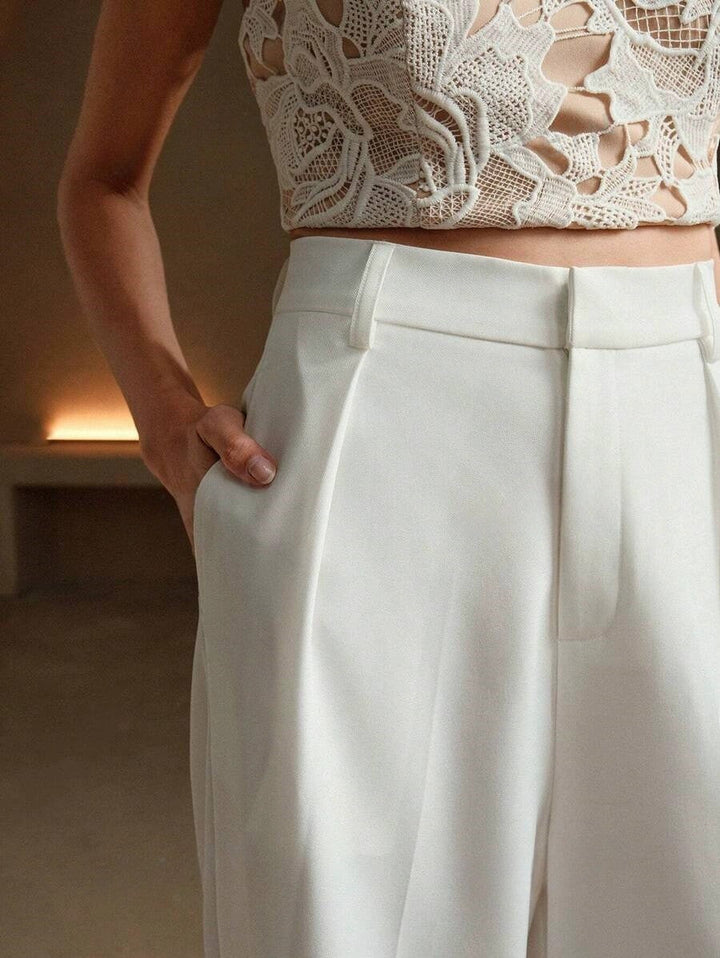 Stella women's high-waist wide-leg white tailored pants with sleek lines, paired with a lace crop top.