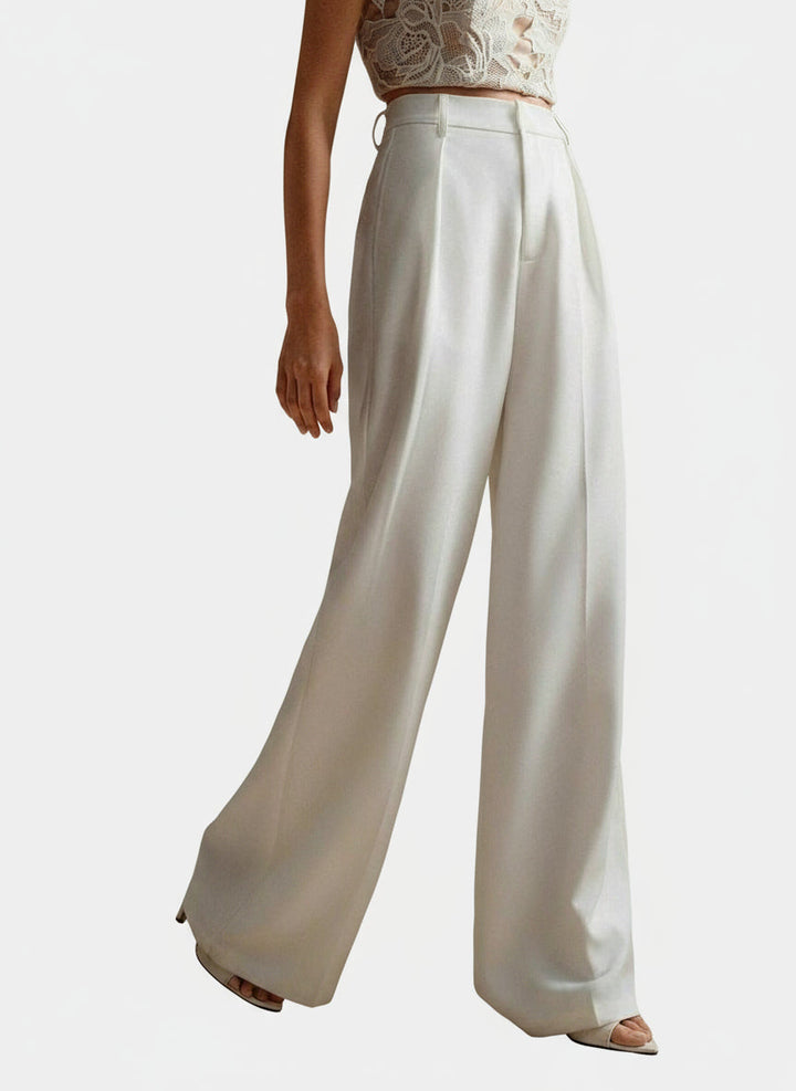 Stella women's high-waist, flowing wide-leg white pants with tailored lines, paired with a lace crop top.