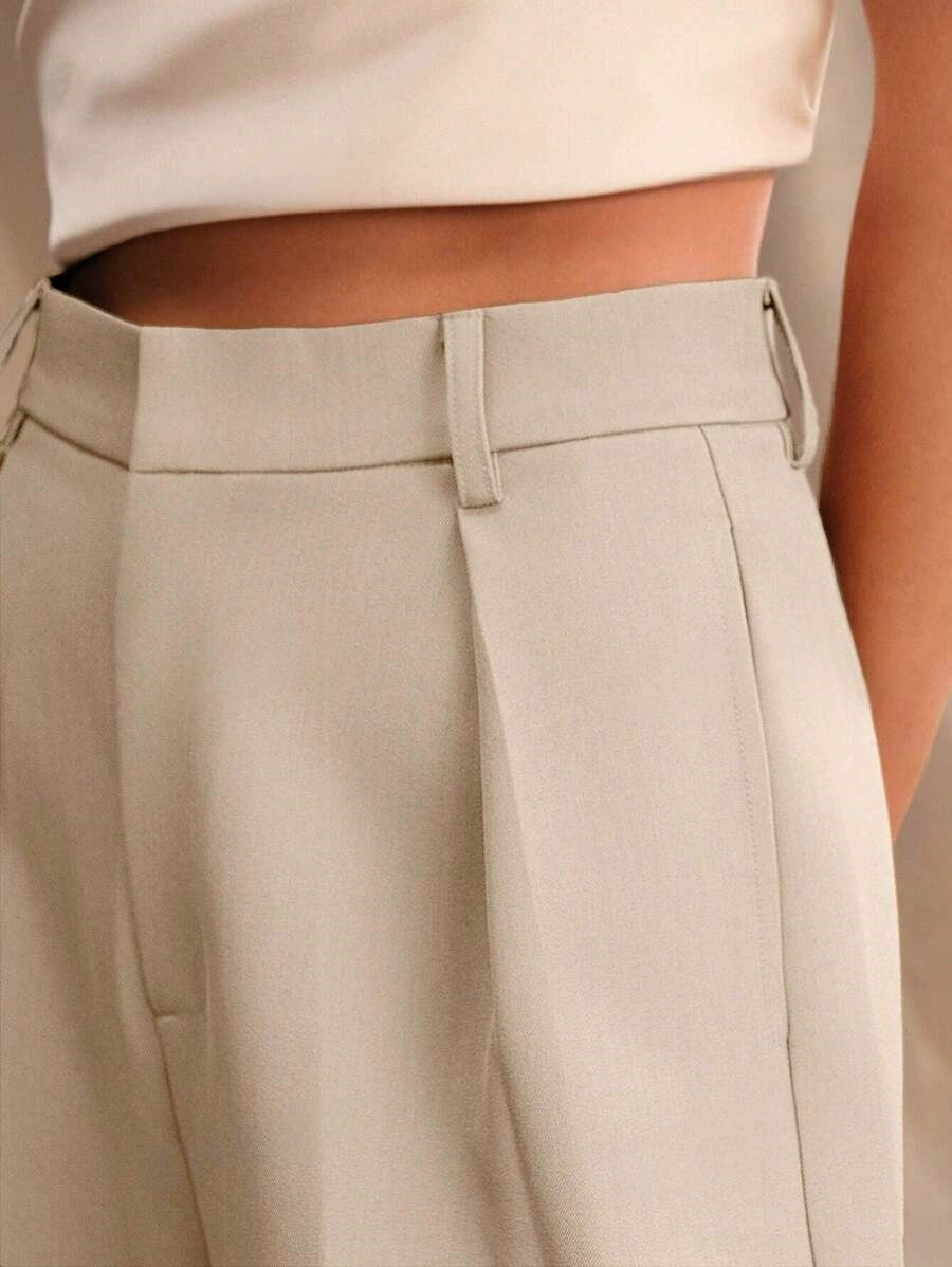 Stella women's high-waist wide-leg pants in a light neutral color, featuring tailored construction and a sleek fit.