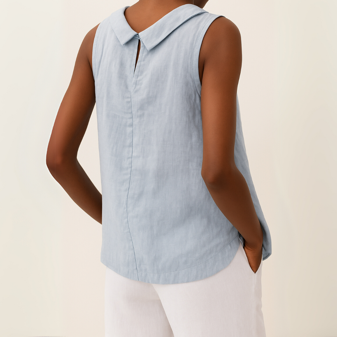 Back view of a light blue sleeveless top with a roll collar and keyhole detail, paired with white trousers.