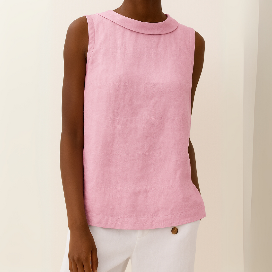 Model wearing a sleeveless, light pink linen-blend top with a modern roll collar and a relaxed, draped silhouette.